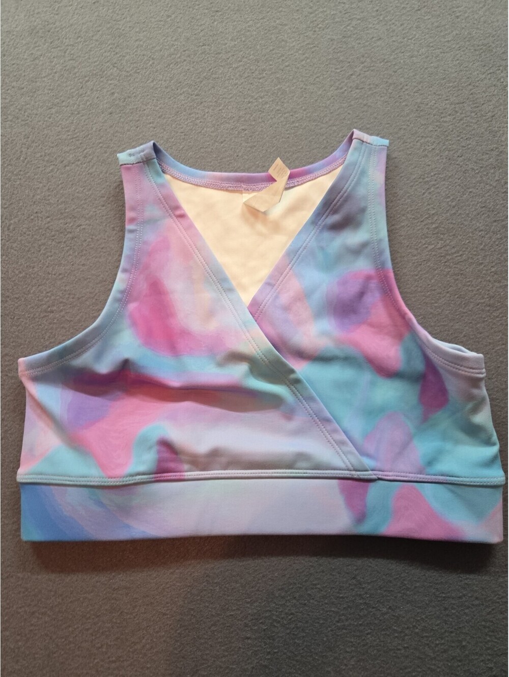 girl's Zella tank crop top features a colorful pink and blue tie-dye pattern